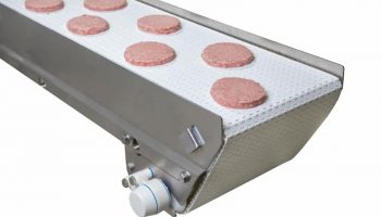 A Dorner AquaPruf conveyor belt transports hamburger patties.